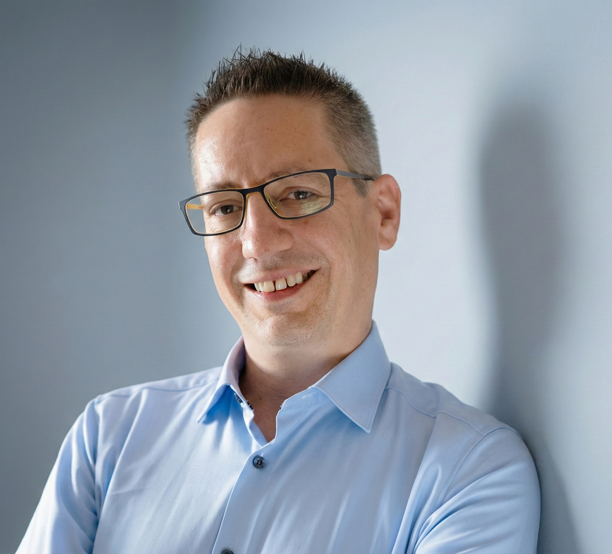 Professional headshot of a consultant in a dark shirt